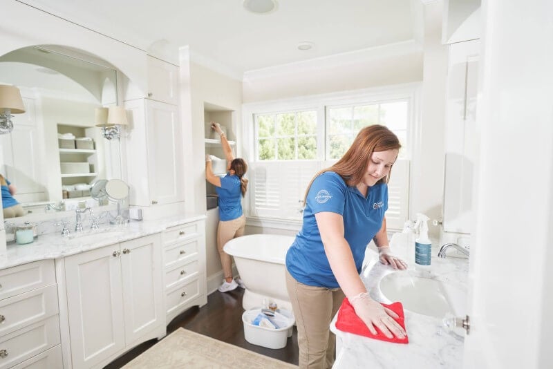 Two maids cleaning bathroom