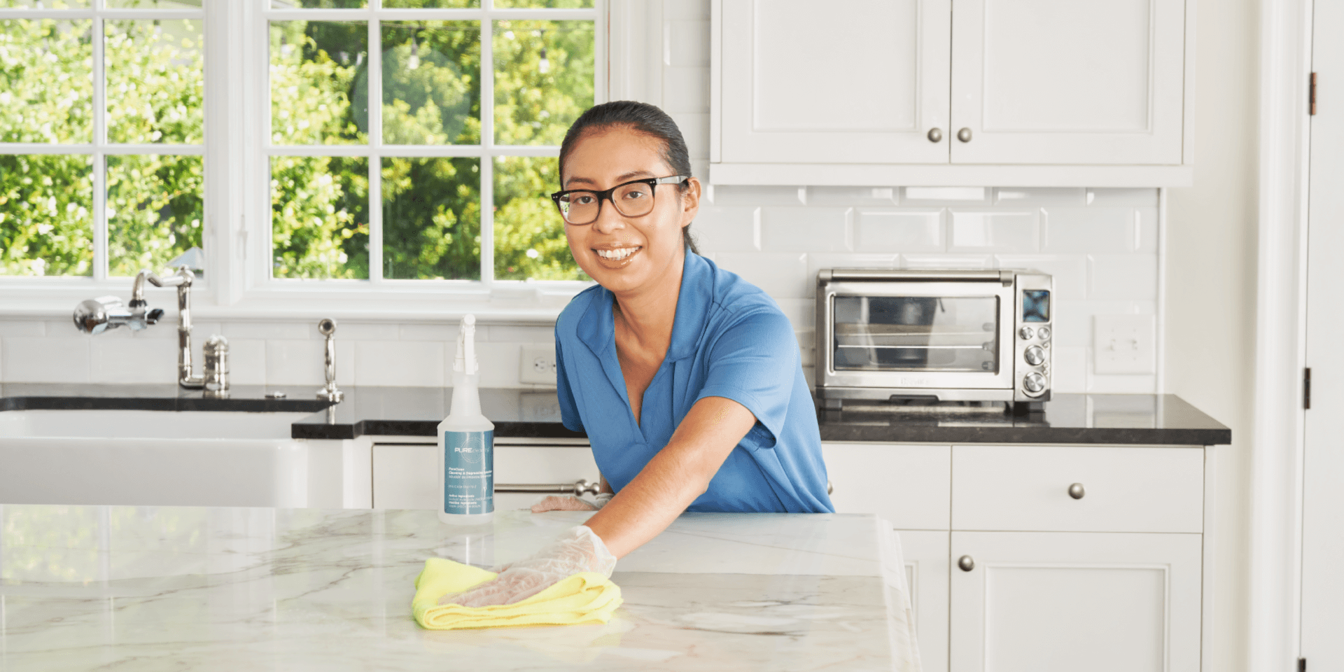 Professional house cleaner wiping countertop