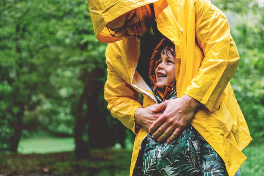 Man and child in rain coats