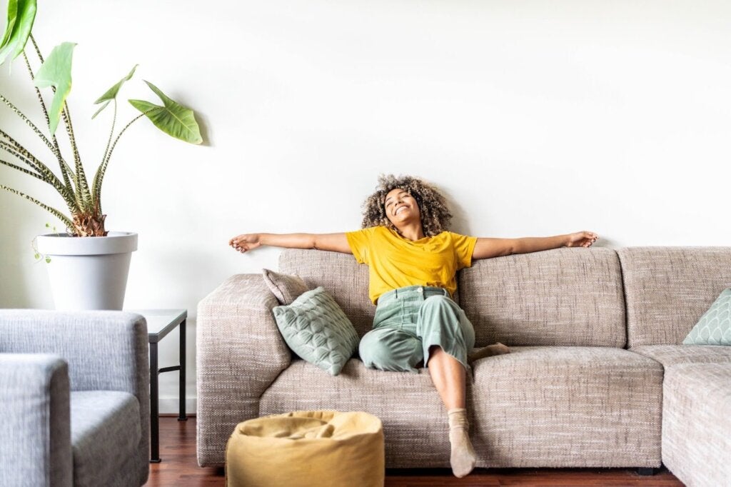 a woman enjoying their clean and healthy living room